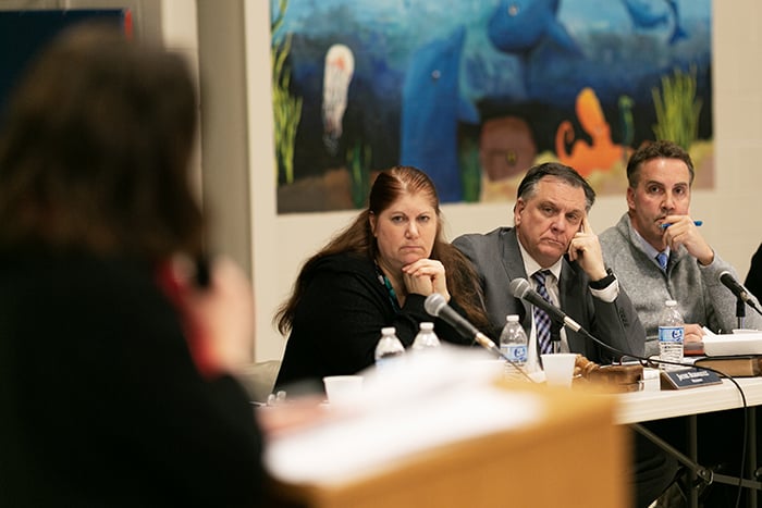 Board president Jackie Bermudez, Superintendent David Trethaway and Business Administrator Craig Lorentzen listen as teacher Ruth Kennedy speaks. (Photo by Jennifer Peacock)