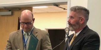 Dennis Filippone, the retiring director of planning, research and evaluation, and Superintendent Gerard Dalton (L to R) handed out certificates to each board member for School Board Recognition Month. (Photo by Judy Smestad-Nunn)