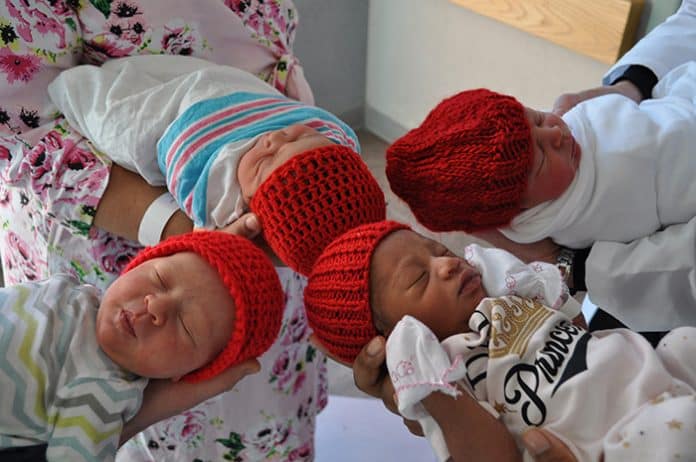 Babies at Jersey Shore Medical Center wear knitted red hats to raise awareness for heart health. (Photo courtesy American Heart Association)
