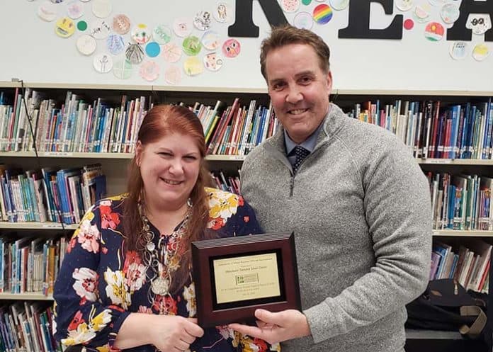 BOE President Jackie Bermudez and Business Administrator Craig Lorentzen with the Certificate of Excellence in Financial Reporting award plaque. (Photo courtesy Manchester Township School District)