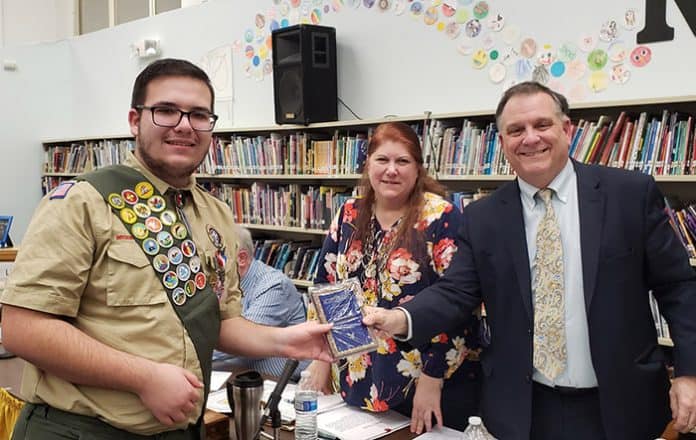 Eric Derco was honored by Board President Jackie Bermudez and Superintendent David Trethaway. (Photo courtesy Manchester Township School District)