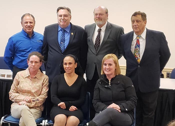 Jackson School Board members assemble during a recent Board of Education meeting. Board member Thomas Colucci, left, standing, Board President John Burnetsky, Michael Walsh, Gus Acevedo, sitting from left are Vicki Grasso, Vice Board President Sharon Dey, and Tara Rivera.