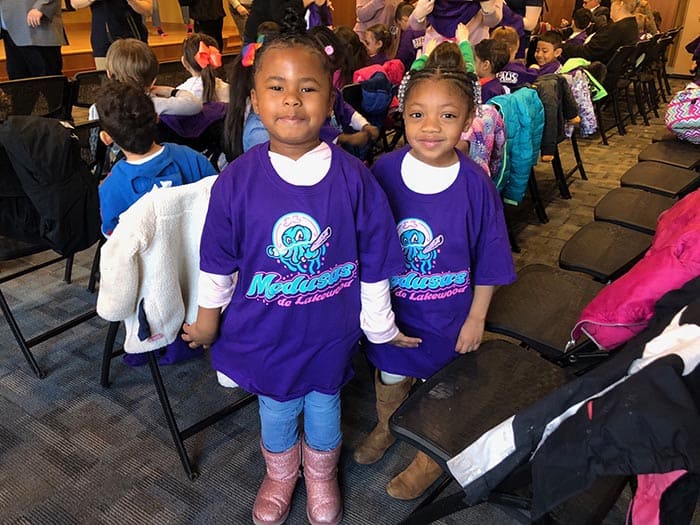 Two O.C.E.A.N., Inc. girls donned their new Medusas shirts over their regular outfits. (Photo by Kimberly Bosco)