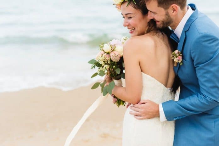 Bride and groom at the beach. (File photo)
