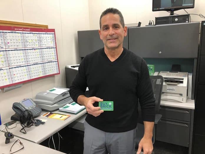 Darren Sirota shows off a Buy in Brick card. (Photo by Judy Smestad-Nunn)