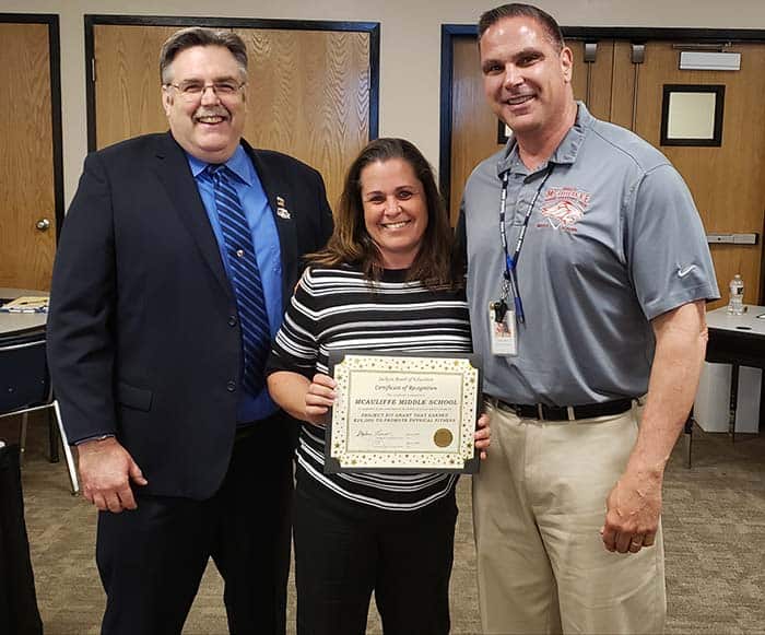 Jackson Board of Education President John Burnetsky, left, joins McAuliffe Middle School teacher Victoria Hay and assistant principal John Lamela in celebrating a $25,000 Project Fit Grant. (Photo by Bob Vosseller)