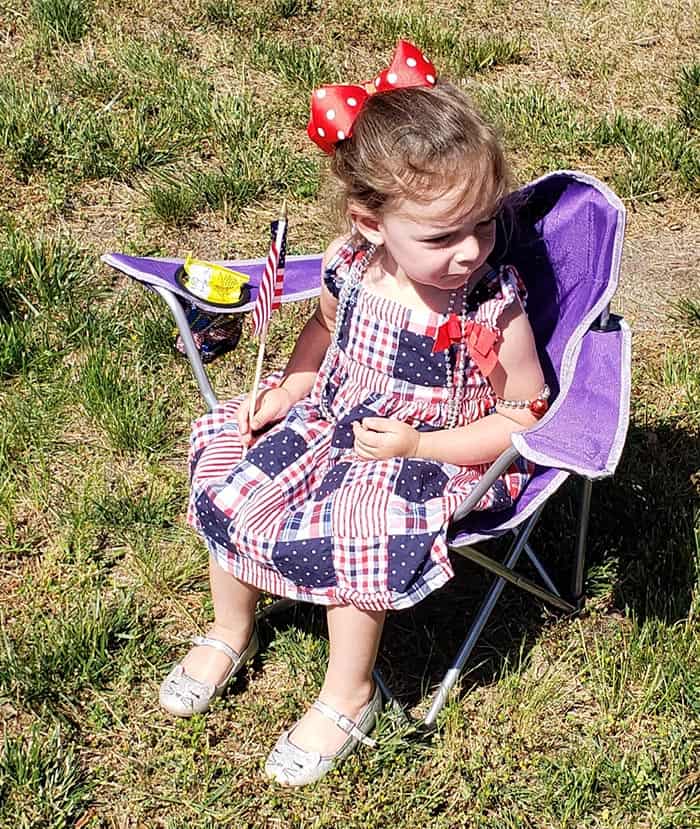 Little Avery Lafontaine, 2, of Jackson sits in comfort during this year’s Memorial Day Parade where she joined four other members of her family including her grandmother Janet Fitzpatrick. (Photo by Bob Vosseller)