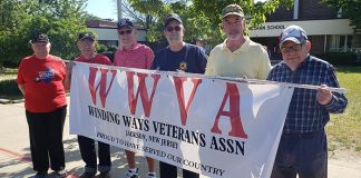 Winding Ways Veteran Association members Les Bauer, left, joins Marvin Stern, Ron Ely, Dave Gould, Bill Ballard and Richard Pudlin prepare for the start of the Jackson Memorial Parade. (Photo by Bob Vosseller)