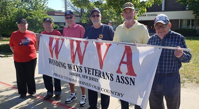 Winding Ways Veteran Association members Les Bauer, left, joins Marvin Stern, Ron Ely, Dave Gould, Bill Ballard and Richard Pudlin prepare for the start of the Jackson Memorial Parade. (Photo by Bob Vosseller)