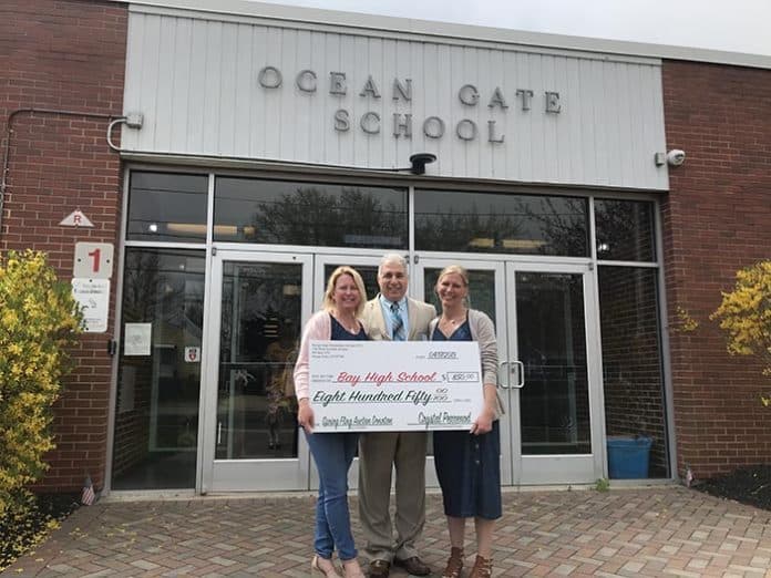 Ocean Gate PTO volunteers Crystal Perrenod and Alisa Capuano, and Superintendent Frank Vanalesti hold the ceremonial check. (Photo courtesy Ocean Gate PTO)