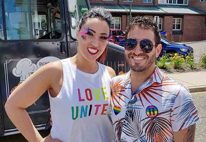 Event volunteers Kelly and Adam Servodio assisted with Pride Day’s first activity which was a festival held on Robbins Street and included games, a scavenger hunt, vendors and several food trucks. (Photo by Bob Vosseller)