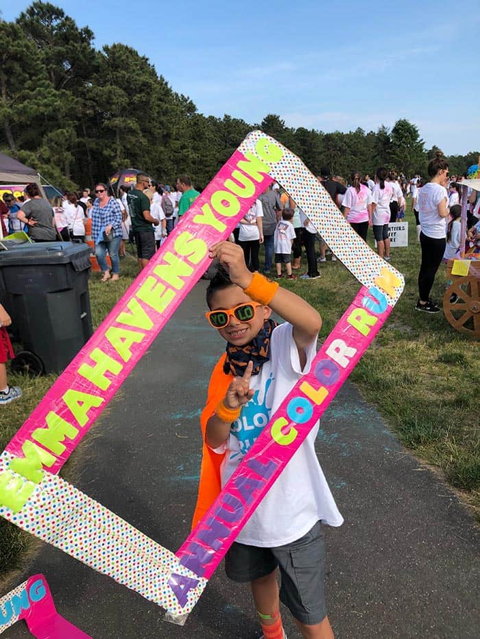 Vincent Policriti, 7, a 1st grader at EHY holds the Color Run frame prop. (Photo by Judy Smestad-Nunn)